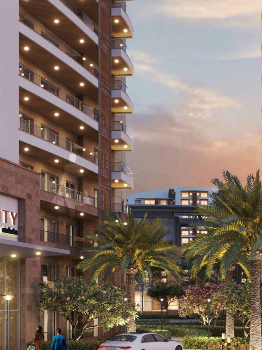 A Rishita Serenity tower at dusk with lit balconies, Sushant Golf City, Lucknow